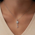 Sterling silver moissanite key pendant necklace worn on model
