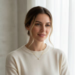 Close-up of gold moissanite necklace on model’s neck in sunlight