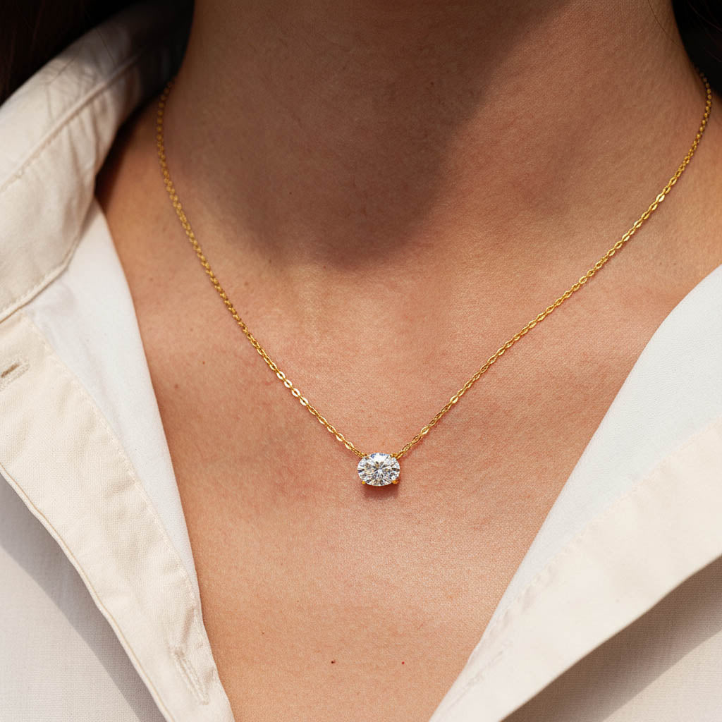 Model wearing 2ct gold moissanite solitaire necklace indoors