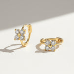 Gold-plated huggie hoops featuring four-petal moissanite flower design