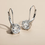 Side-angle detail of lever-back earrings showing stone setting and shine.