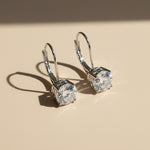 Silver lever-back earrings with 1ct round D/VVS1 lab diamond moissanite.