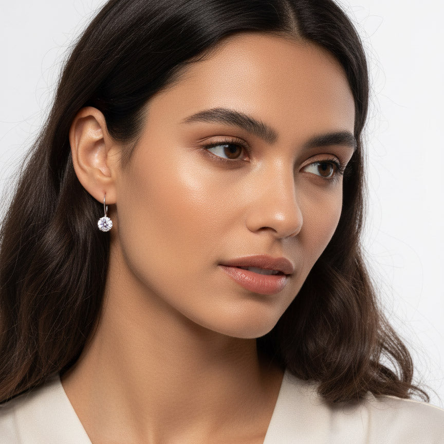 Model wearing 1ct lab diamond moissanite lever-back earrings in silver.