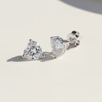 Close-up of platinum-plated heart-cut moissanite studs with butterfly backs