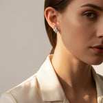 Model wearing star moissanite stud earrings for everyday elegance