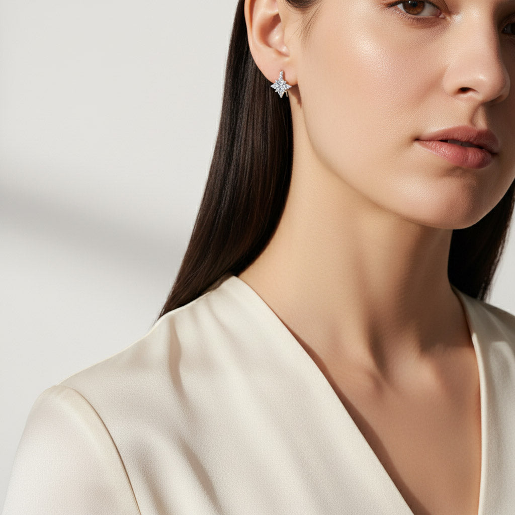 Close-up of a woman wearing a star-shaped earring against a neutral background