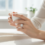 Elegant platinum plated moissanite ring with halo design on model hand