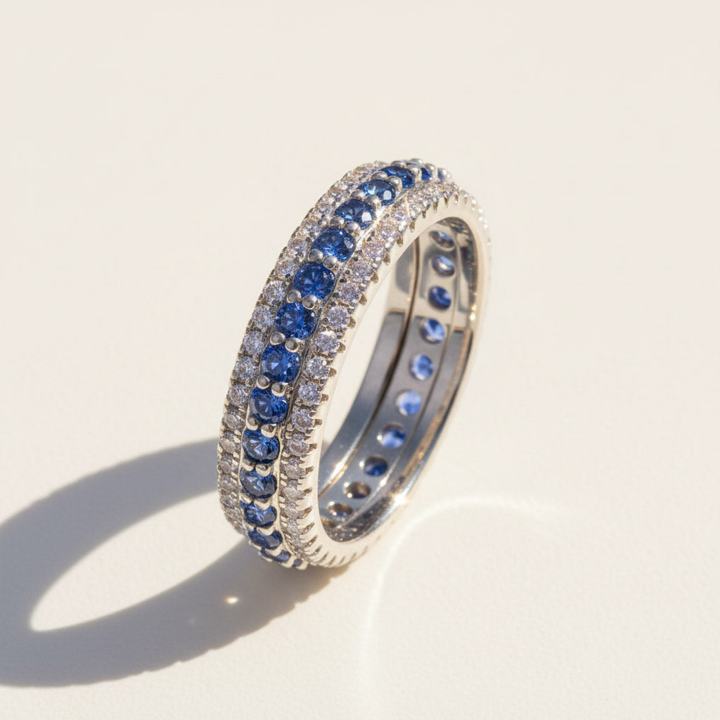 Sapphire blue moissanite eternity ring in platinum plated sterling silver