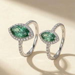 1ct and 2ct green marquise moissanite on a beige background