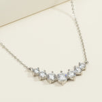 Sterling silver necklace with seven round lab-grown diamonds in a curved bar design