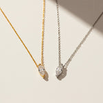 Gold and silver marquise-cut 1ct lab grown moissanite necklaces shown side by side on a light background