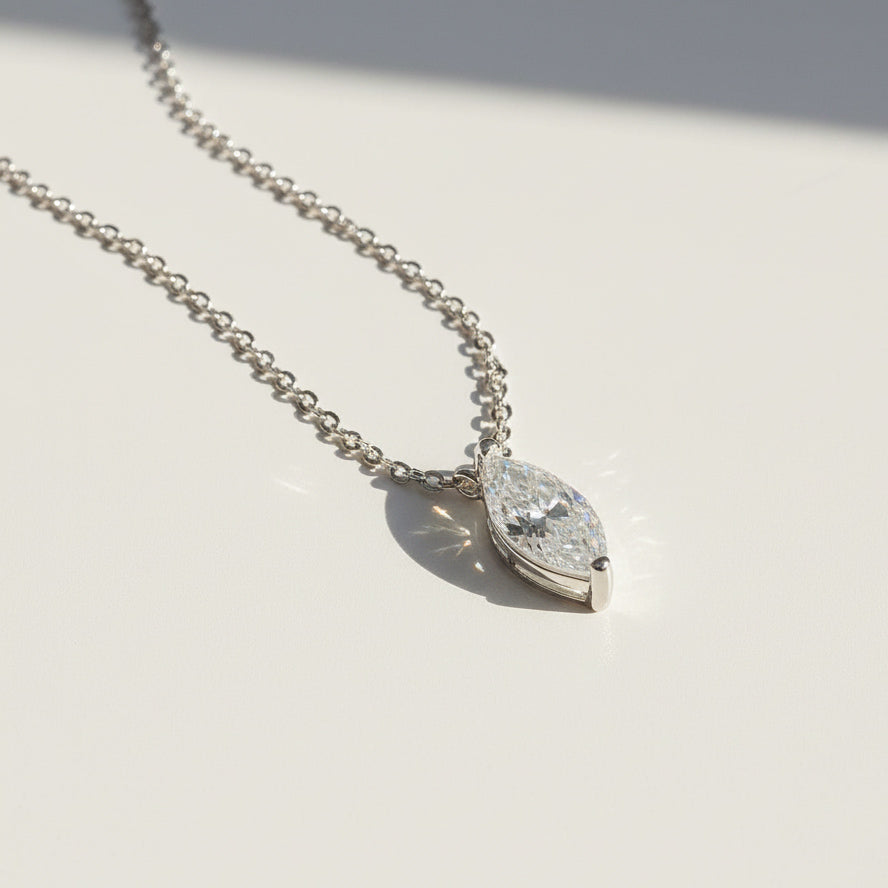 Side angle of 0.1ct marquise moissanite pendant on sterling silver chain.