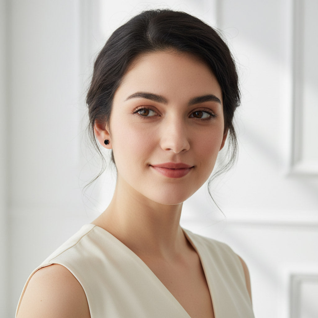 Side view of woman wearing black moissanite stud earrings, platinum setting.