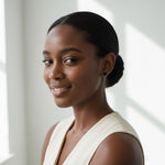 Woman with dark hair wearing black moissanite stud earrings, close-up portrait.