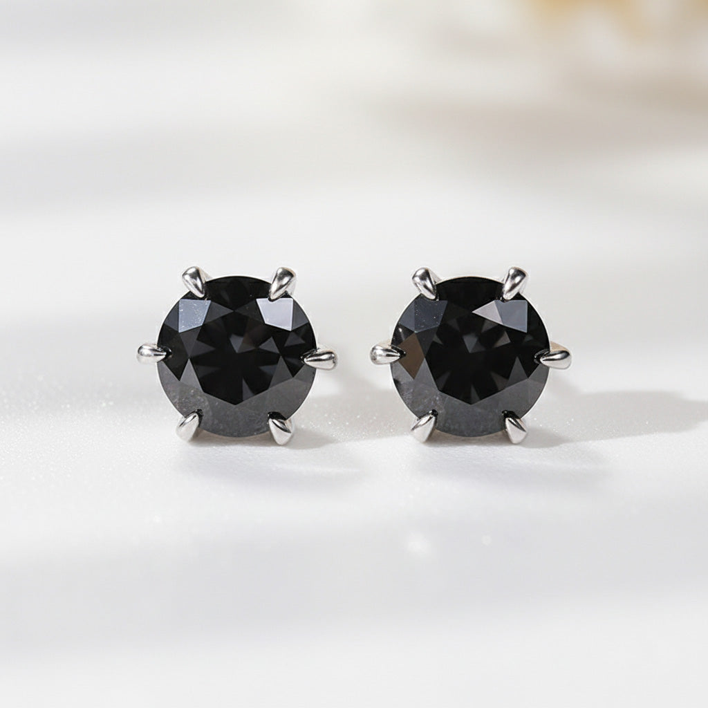 Close-up of black moissanite stud earrings in platinum-plated silver.