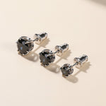 Three pairs of black moissanite stud earrings in different carat sizes.