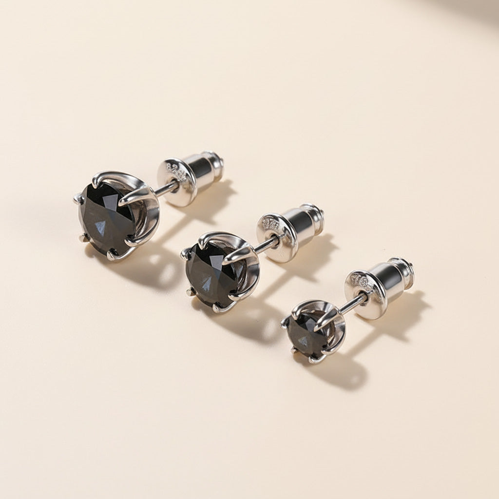 Three pairs of black moissanite stud earrings in different carat sizes.