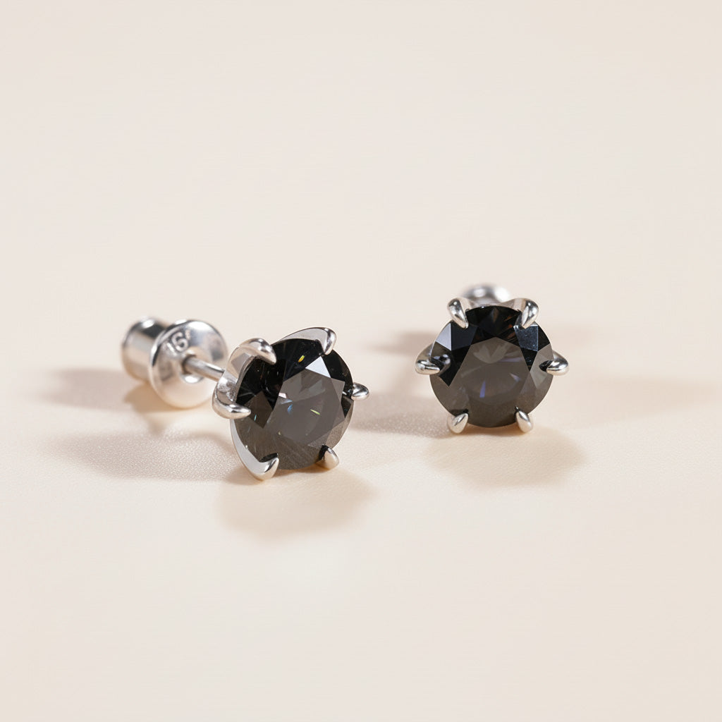 Pair of black moissanite earrings showing secure prong setting and backs.