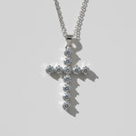 Platinum-plated silver cross necklace with 11 round VVS1 moissanite stones on a clean white background