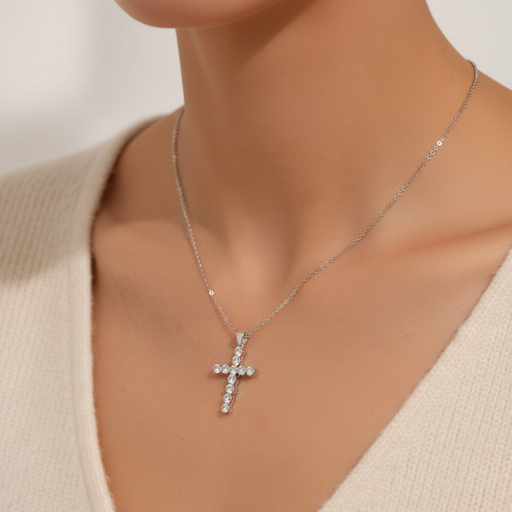 lose-up of VVS1 moissanite cross necklace on model’s neckline in soft studio lighting