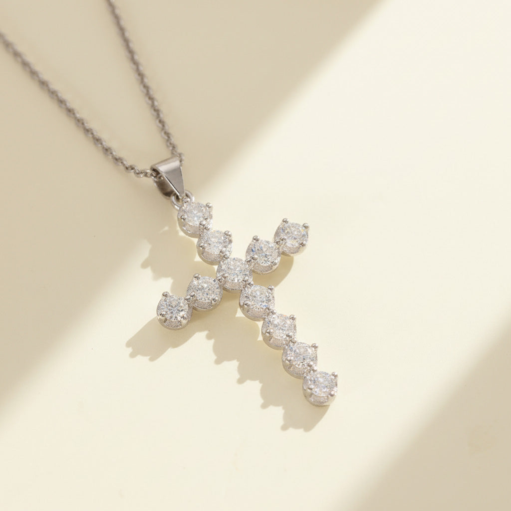 Sparkling VVS1 moissanite cross pendant in platinum-plated silver displayed under warm sunlight