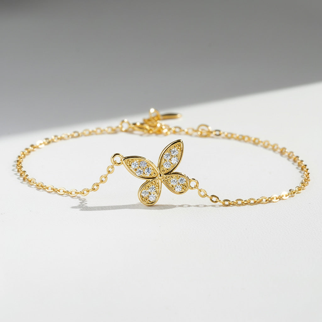 Gold-plated moissanite butterfly bracelet with 11mm pendant on a light surface