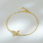 Gold-plated moissanite butterfly bracelet displayed on soft textured background