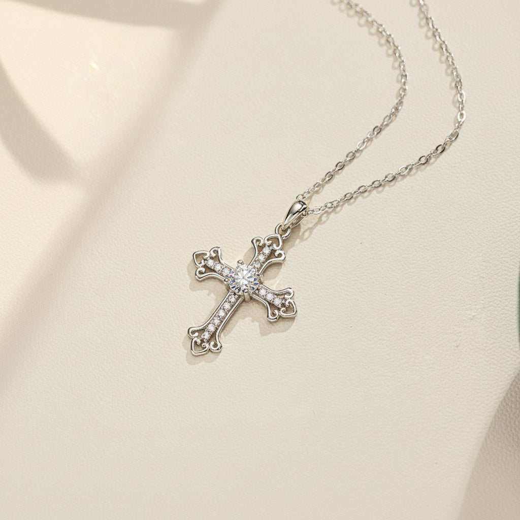Moissanite cross pendant necklace in sterling silver on white background