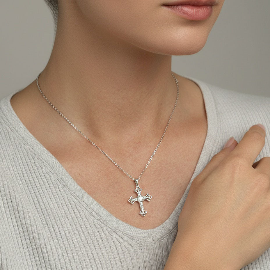 Model wearing sterling silver moissanite cross necklace