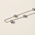 Close-up of moissanite pendant with 6.5mm and 5mm stones on silver chain