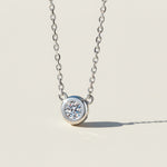 Bezel set moissanite necklace in sterling silver, 0.5ct round lab diamond.