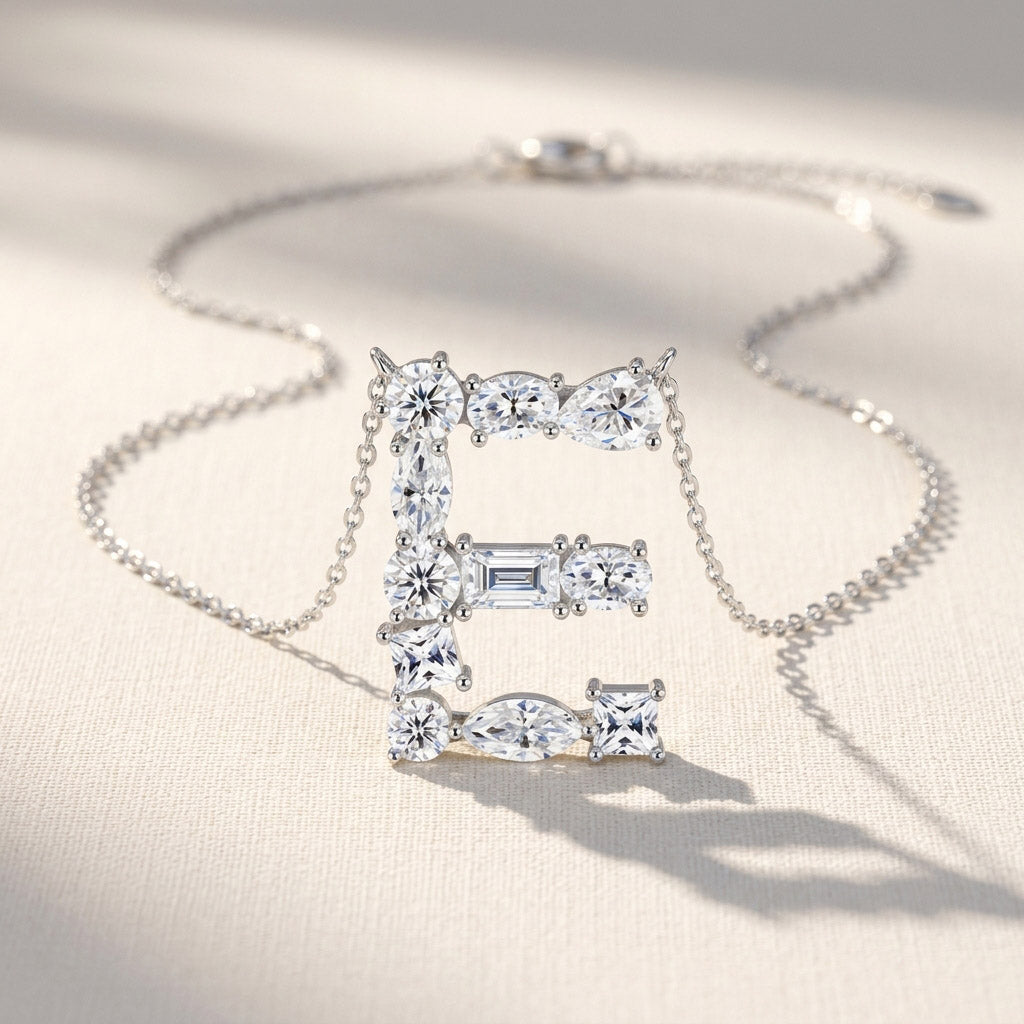 Diamond necklace with 'E' pendant on a light background