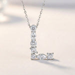 Diamond necklace with a 'L' shape on a soft gradient background