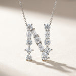 Diamond necklace with a letter 'N' pendant on a light background