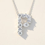 Diamond necklace with a letter 'P' pendant on a light background