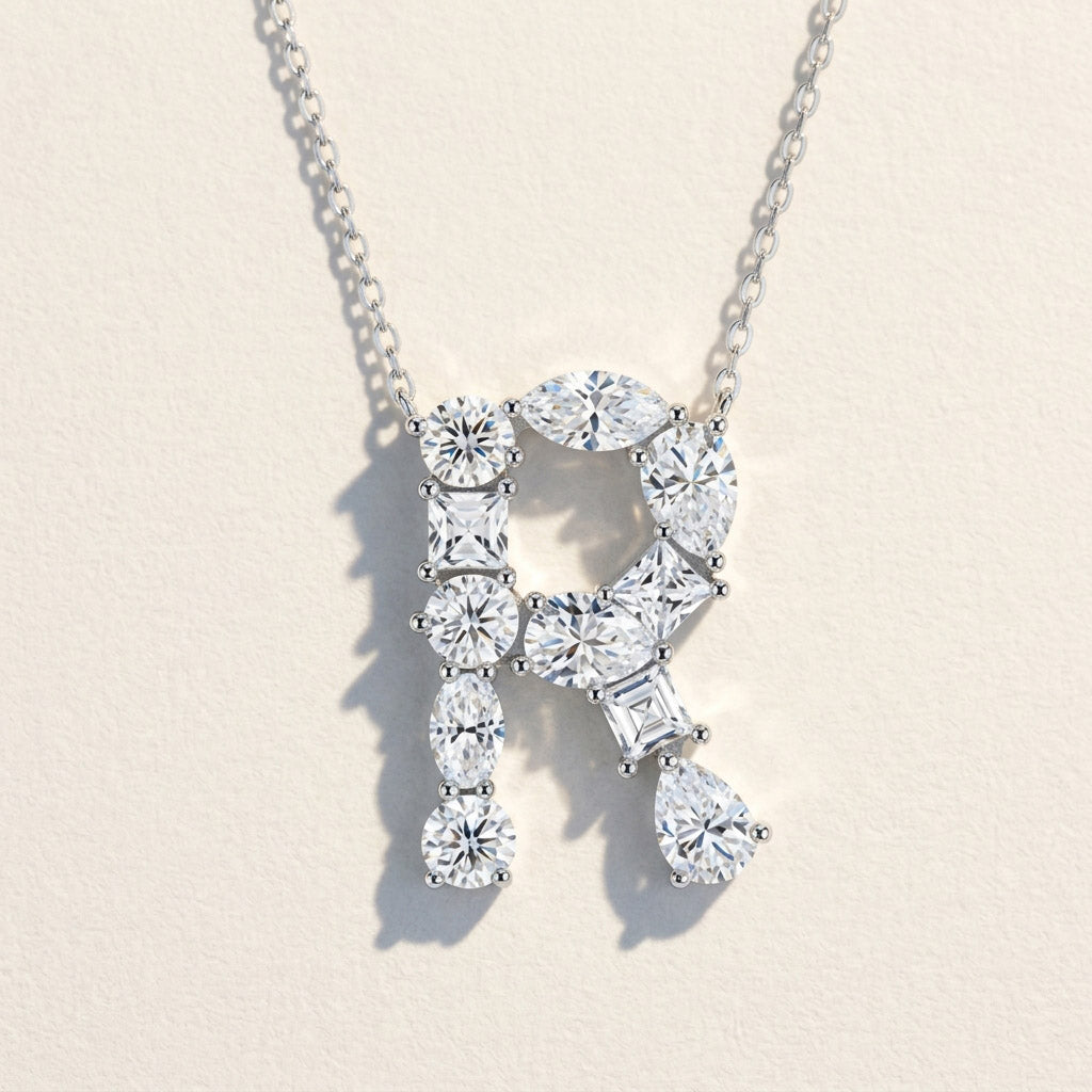 Diamond necklace with a 'R' design on a light background