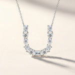 Diamond necklace with a 'U' design on a light background