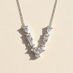 Diamond necklace with a 'v' design on a light background