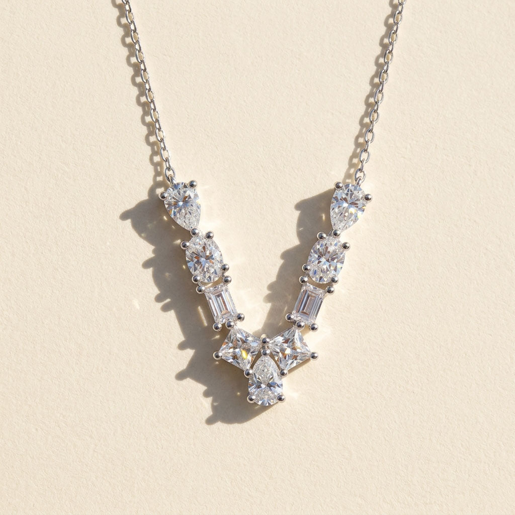 Diamond necklace with a 'v' design on a light background