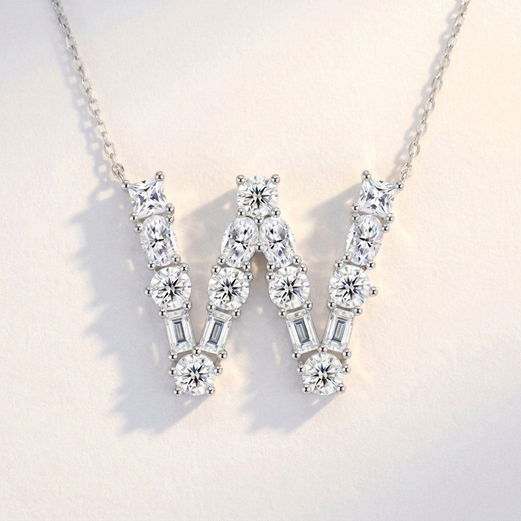 Diamond necklace with a 'W' design on a light background