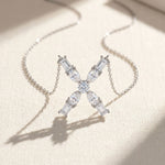 Diamond necklace with a 'X' design on a light background