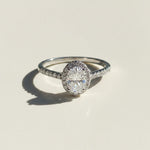 Moissanite diamond ring on a light beige background
