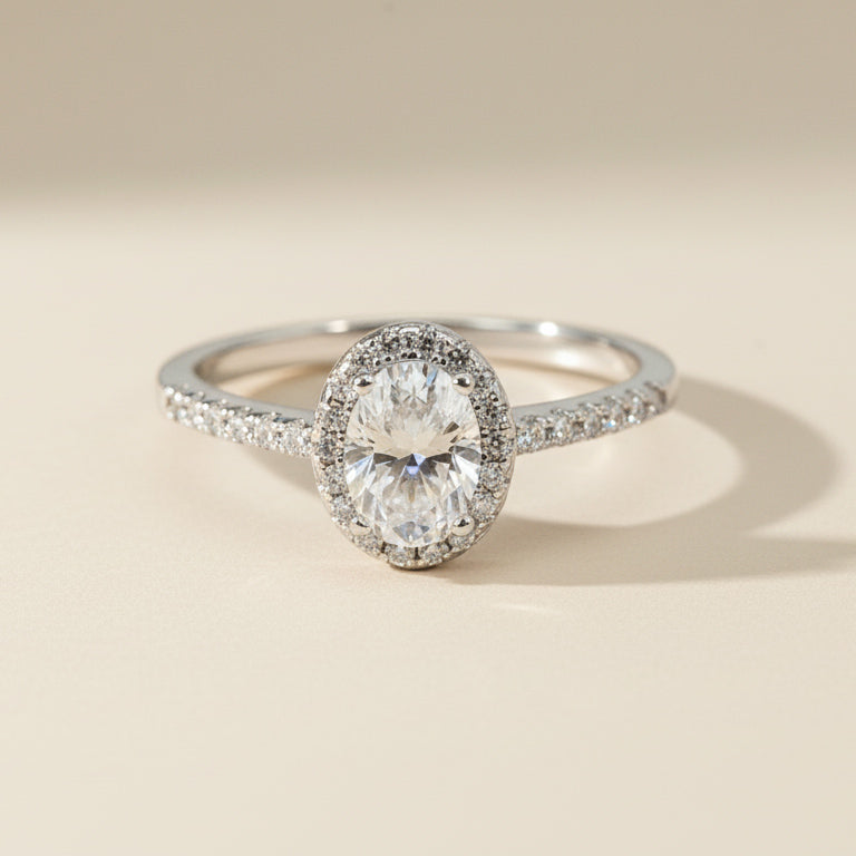 Sterling silver engagement ring with oval-cut lab-grown diamond and halo setting