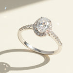 Elegant oval halo ring featuring lab-grown diamond center and pavé-set silver band