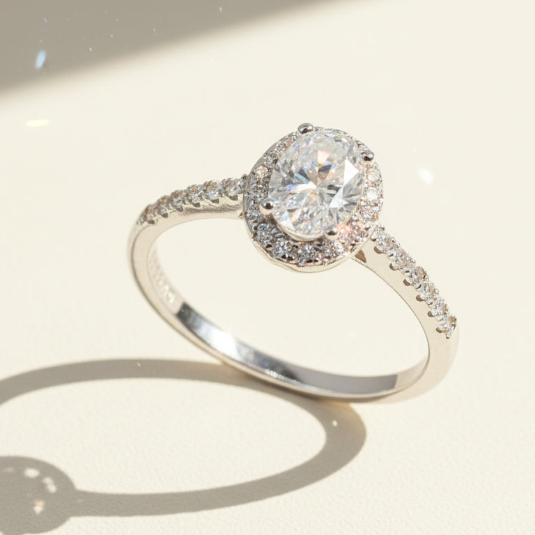 Elegant oval halo ring featuring lab-grown diamond center and pavé-set silver band