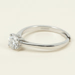 Side view of silver solitaire ring featuring round-cut lab-grown diamond in six-claw mount