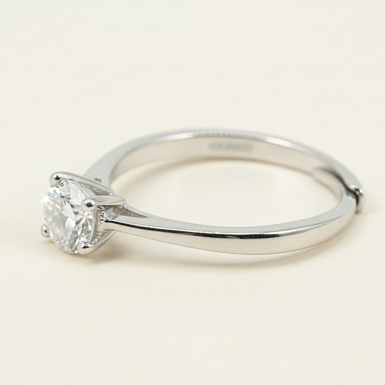 Side view of silver solitaire ring featuring round-cut lab-grown diamond in six-claw mount