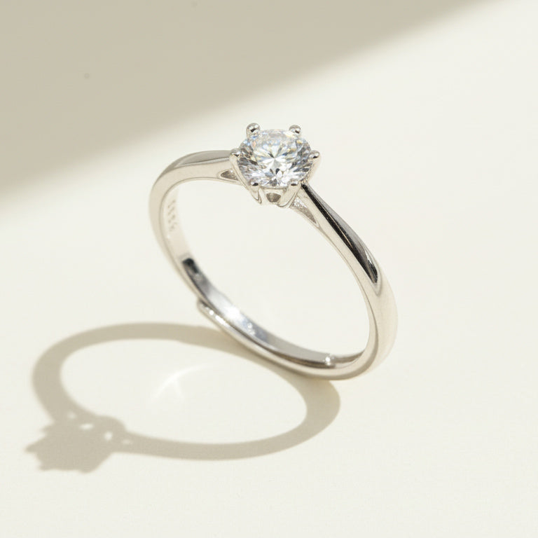 Angled close-up of classic six-prong round diamond solitaire ring in sterling silver