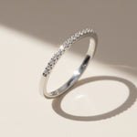 Silver diamond eternity ring with pavé-set round lab-grown diamonds reflecting natural light