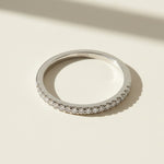 Close-up of sterling silver eternity ring with pavé-set round diamonds marked S925 inside band